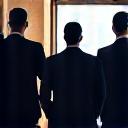 Silhouette of highly trained security personnel standing guard at an event entrance, conveying professionalism.